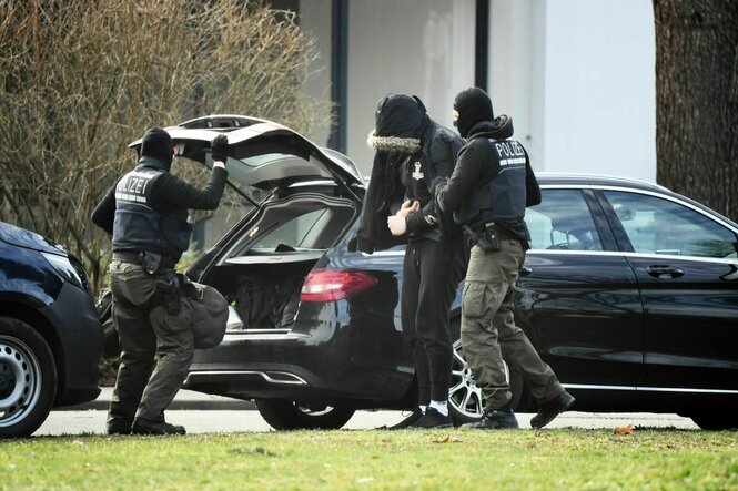 Auto mit offenem Kofferraum, Menschen