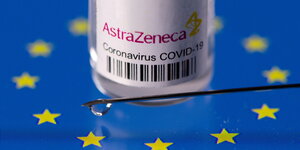 AstraZeneca Impfstof-Fläschchen mit Kanüle auf EU Symbol