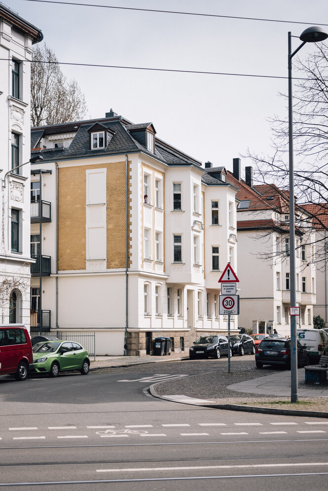 Ein vierstöckiges Wohnhaus an einer Straße