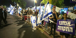 Menschen mit israelischen Flaggen in der Nacht