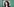 Bettina Jarrasch steht vor einem grünen Hintergrund