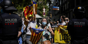 bei einer Demonstration halten eine Gruppe protestierende die katalonische Unabhängikeitsflagge hoch