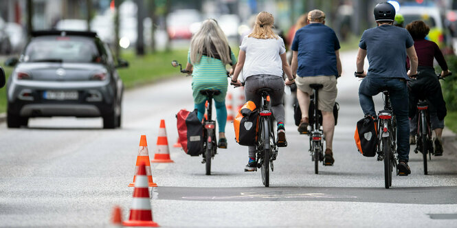 4 Menschen fahren nebeneinander Fahrrad