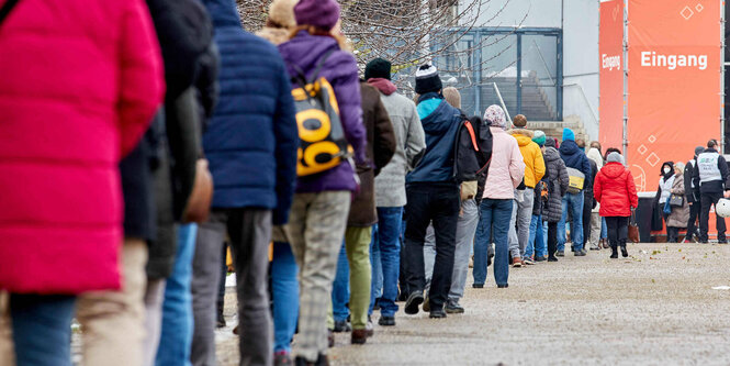 Eine lange Schlange an Wartenden vor dem Testzentrum