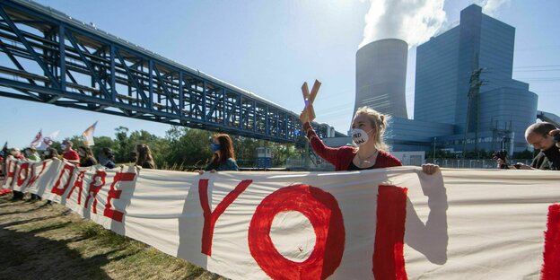 Demonstration gegen das umstrittenen neue Steinkohlkraftwerk Datteln IV - Demonstreirende halten vor dem Kraftwerk ein Banner mit der Aufschrift "How dare you"