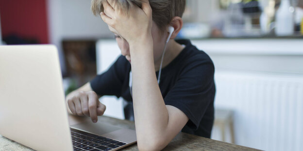 Ein frustrierter Junge am Laptop