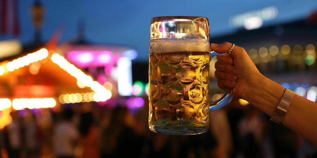 eine Frau Hält einen Bierkrug in die höhe