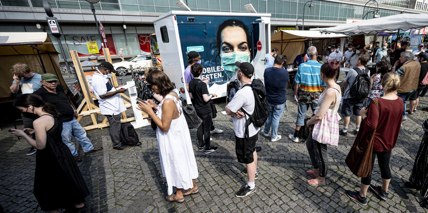 Menschen stehen Schlange um geimpft zu werden