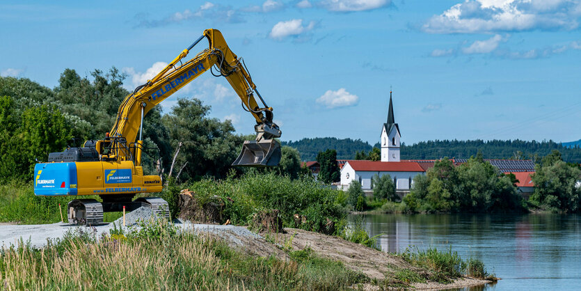 Bagger an Aktion an enem Flussufer