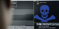 Bildschirm zeigt Befehle und Programmiercodes in einem Terminal. Die Buchstaben bilden einen blauen Totenkopf