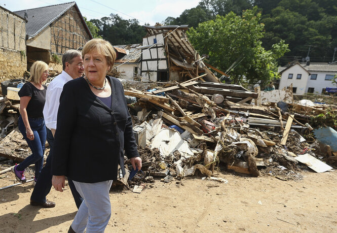 Kanzlerin Merkel vor Trümmern.