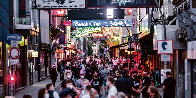 Menschen gehen durch die Reeperbahn-Seitenstraße Große Freiheit.