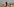 Verhüllte Frau mit 2 kleinen Kindern in wüster Landschaft vor wüstem Häusermeer