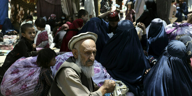 Männer und Frauen sitzen in einem Park in Kabul