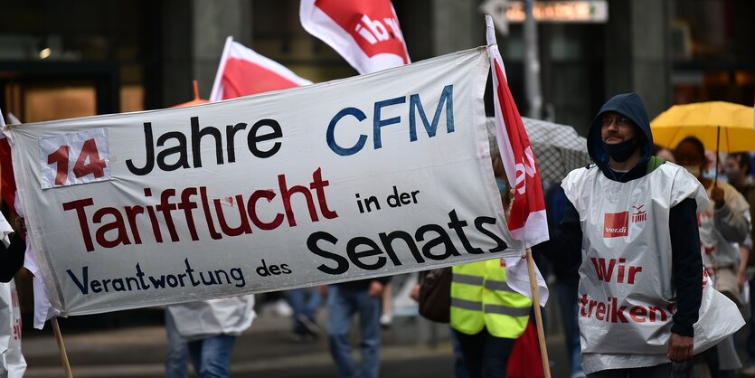 Beschäftigte der Charité Facility Management (CFM) demonstrieren, um die Gewerkschaft Verdi im Tarifkonflikt zu unterstützen. Die Tochtergesellschaft der Charité erbringt an den Charité-Standorten Dienstleistungen wie etwa Abfallentsorgung oder Reinigung.