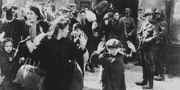 Menschen mit erhobenen Händen im Warschauer Ghetto 1943