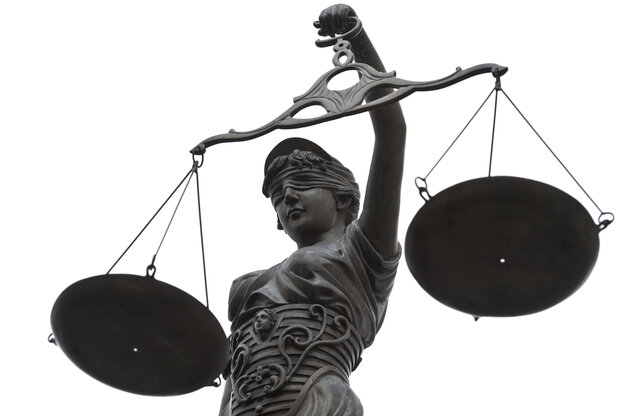 Das Foto zeigt eine Skulptur der Justizia, Symbol der Rechtsprechung, mit einer Waage in der Hand