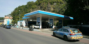 Eine Tankstelle, ein Polizeiauto parkt in der Nähe