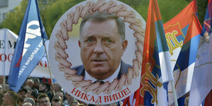 Kopf des bosnisch-serbischen Präsidenten Dodik auf einem Plakat "Niemals wieder"