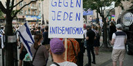 Kundgebung mit Schild, auf dem "Gegen jeden Antisemitismus" steht.