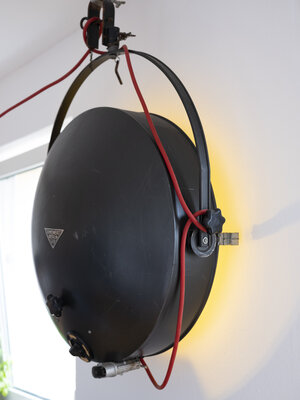 Ein Schweinwerfer als Beleuchtung an einer Wand Ein Schweinwerfer als Beleuchtung an einer Wand