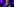 Ein Mann im Anzug mit Brille vor einem bunten Hintergrund
