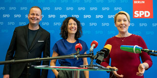 Klaus Lederer, Bettina Jarasch und Franziska Giffey stehen bei einer Pressekonferenz zusammen