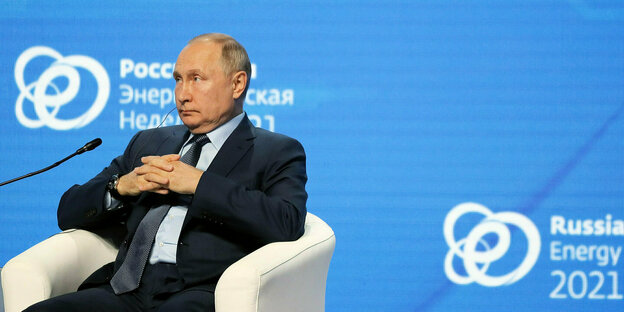Wladimir Putin sitzt in einem Sessel und schaut grimmig