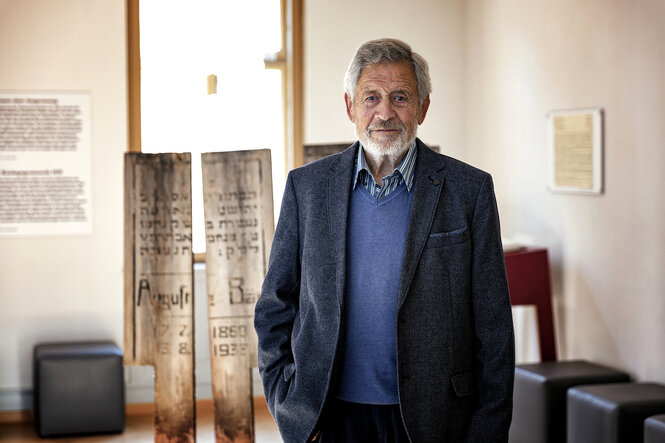 Eberhard Zacher steht im Museum vor Beerdigungshölzern