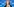 Karin Prien vor blauem Hintergrund. Sie ist eine Frau mittleren Alters, hat schulterlanges rötliches Haar und trägt am linken Ringfinger einen Ring. Sie gestikuliert und redet in ein Mikrofon.