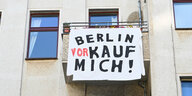An dem Balkon eines Hauses hängt ein Transparent: Berlin Vorkauf mich