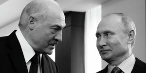 Präsident Lukaschenko und Präsident Putin schauen sich an.