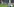 Ein Spieler von Werder Bremen fliegt gerade durch die Luft, ein Spieler von schlake 04 liegt auf dem Rasen
