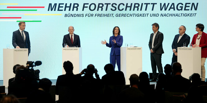 Christian Lindner, Olaf Scholz, Annalena Baerbock spricht, Robert Habeck, Norbert Walter-Borjans und Sskia Esken stehen vor dem Slogan 