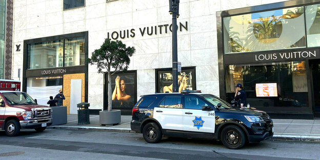 Ein Fahrzeug der Polizei vor einem Louis-Vuitton-Shop