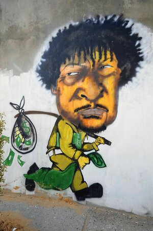 Wandbild von Gaddafi mit Geldsack