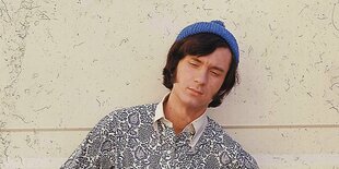 Porträt eines jungen Mannes, Michael Nesmith, der eine blaute Strickmüte trägt und ein Hemd mit schwarzweißem Paisleymuster