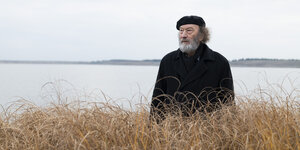 Rolf Kuhn, Ex-Direktor des Bauhauses Dessau, steht vor einem See