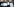 Menschen mit umgehängten Plakaten stehen nebeneinander