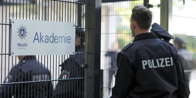 Polizisten betreten in Uniform die Hamburger Polizeiakademie