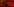 Eine Theke mit Gläsern darauf, in rotes Licht getaucht