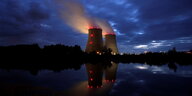 Zwei Türme eines Atomkraftwerks in der Dunkelheit.