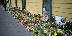 Blumen und Beileidsbekundungen vor einem Haus