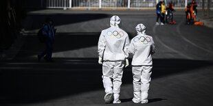 Zwei Personen in Schutzanzügen bei den Olympischen Spielen in Peking.