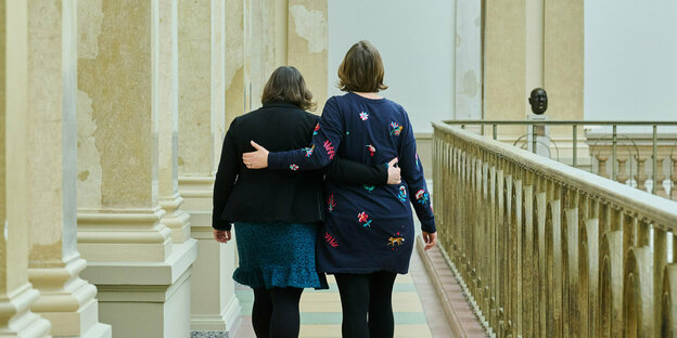 Zwei Frauen wurden von hinten fotografiert, während sie laufen. Sie umarmen sich. Es handelt sich um Atnje Kapek Fraktionsvorsitzende der Grünen und ihre Amtskollegin Silke Gebel