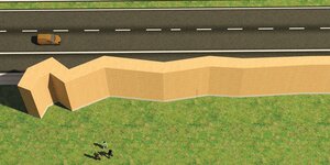 Das Modell einer Schallschutzmauer aus Lehm am Rand der Autobahn