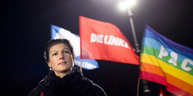 Sarah Wagenknecht vor Partei- und Firedensfahnen