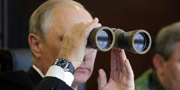Wladimir Putin blickt durch einen Feldstecher