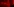Ein in rotes Licht getauchtes Schlafzimmer. Hinter dem ungemachten Bett eine Tapete im Tiger-Look