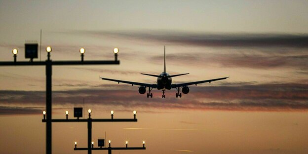 Ein Flugzeug beim Landeanflug im Sonnenuntergang